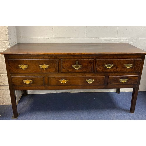 424 - A Georgian oak dresser base/sideboard, fitted with an arrangement of six drawers on straight legs -