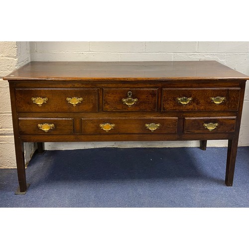 424 - A Georgian oak dresser base/sideboard, fitted with an arrangement of six drawers on straight legs -