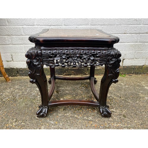 427 - A carved Chinese hardwood table, with elaborately carved frieze, marble inset top and claw and ball ... 