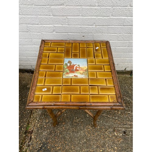 428 - A bamboo framed side table, with tile inset top -