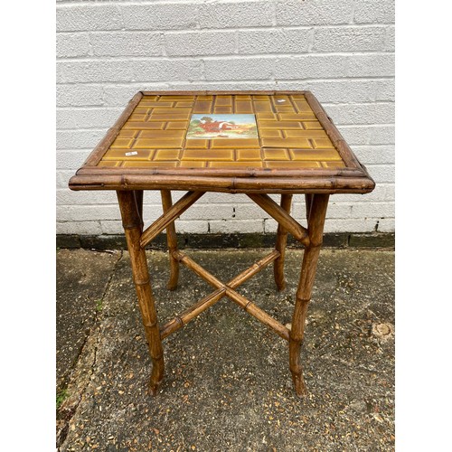 428 - A bamboo framed side table, with tile inset top -