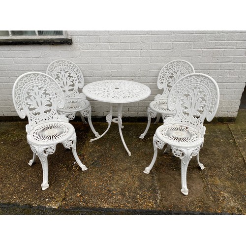 467 - A cast iron table and four chairs -