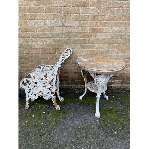 465 - A cast iron table and a pair of bench ends -