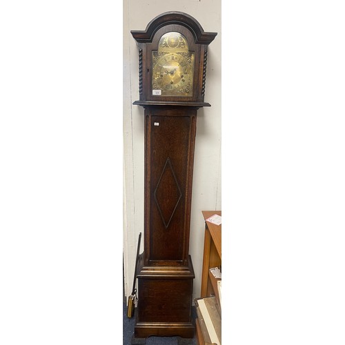 429 - An oak cased grandmother clock, with brass dial -