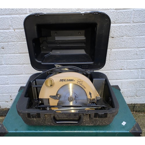 357 - A cased Skilsaw, together with a green painted metal bound trunk -