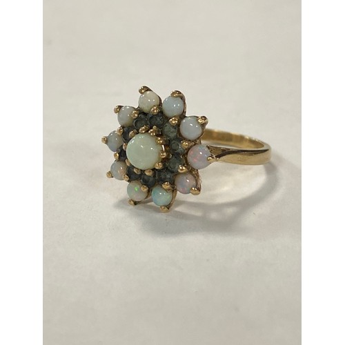 18 - An opal cluster ring, set with opals and green stones, to 9ct gold mount -