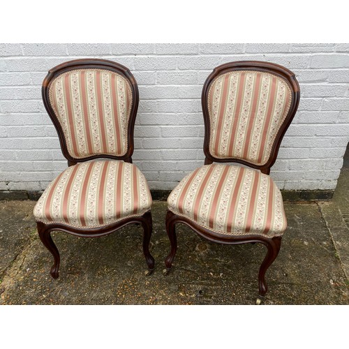 284 - A pair of Victorian rosewood chairs, with floral upholstery -