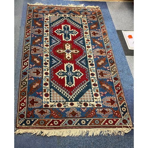 288 - A red and blue ground rug, approximately 190 x 120cm -