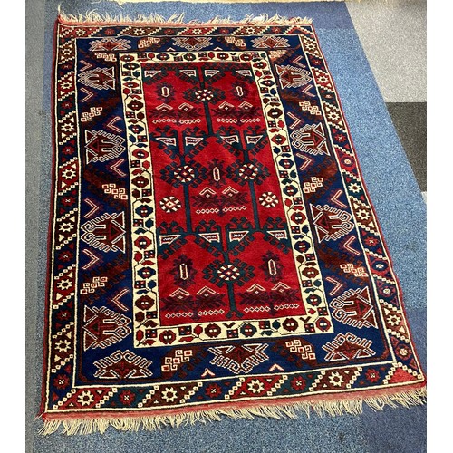 290 - A red and blue ground rug, approximately 182 x 120cm -