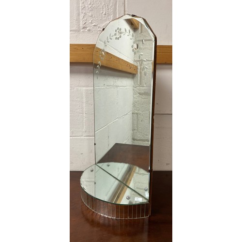 296 - A mid 20th century vanity mirror/display, with etched decoration to arched top over mirrored shelf -