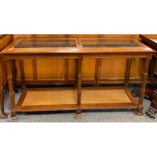 301 - A modern hall table, with glass inset top over turned supports and rattan undertier -