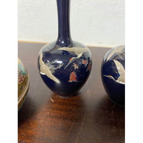 79 - A pair of Japanese cloisonne vases, each decorated with cranes on a blue ground (a/f) and a Satsuma ... 