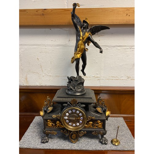 329 - A cast metal figural mantel clock, the base with putto to frieze -