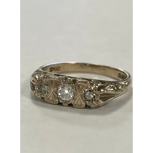 46 - A diamond three stone ring, the central diamond flanked by smaller illusion set diamonds, in 18ct wh... 