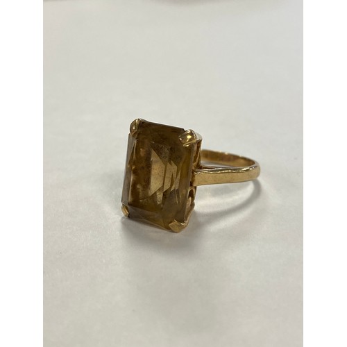 47 - A citrine single stone ring, the rectangular shaped stone claw set in 9ct gold mount -