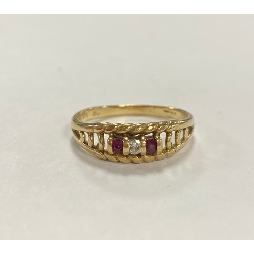 49 - A ruby and diamond three stone ring, the central diamond flanked by rubies, to 9ct gold mount -