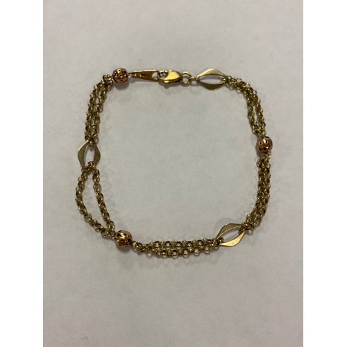 57 - A 9ct gold bracelet, composed of oval open links, chain links and ball spacers -