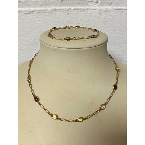 58 - A 9ct gold multi-gem set necklace and bracelet suite, each piece spectacle set with a coloured semi-... 