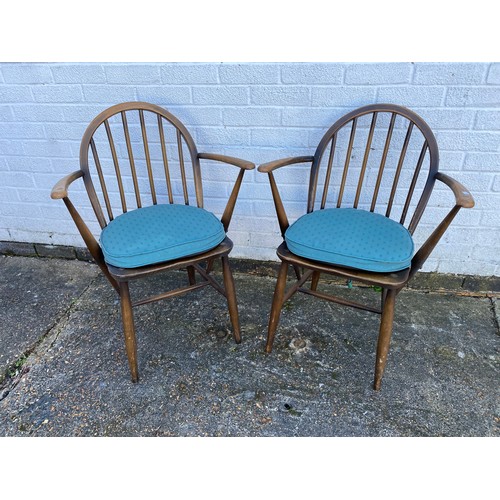 331 - A pair of Ercol open armchairs -