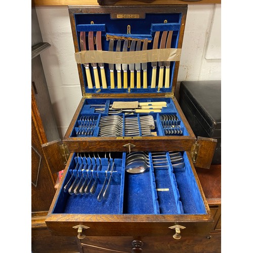 11 - An oak cased canteen of cutlery, with keys -