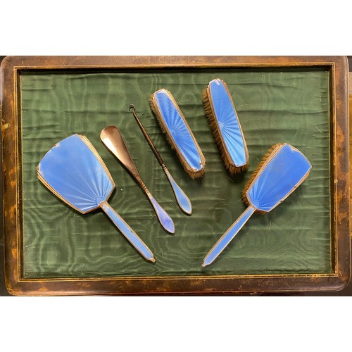 25 - A silver and enamel dressing table set, Birmingham 1932, each piece decorated with blue enamel (loss... 