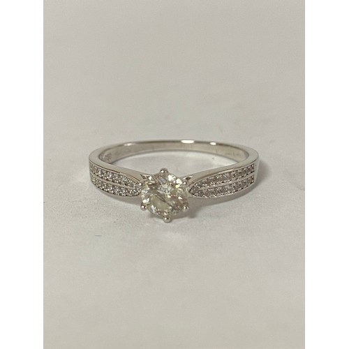 38 - A diamond single stone ring,  the brilliant cut diamond betweenn stone set shoulders, in 18ct white ... 