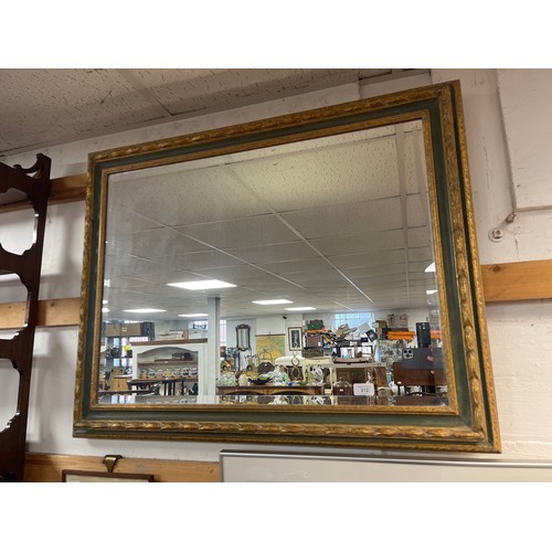 312 - A green and gilt framed wall mirror -