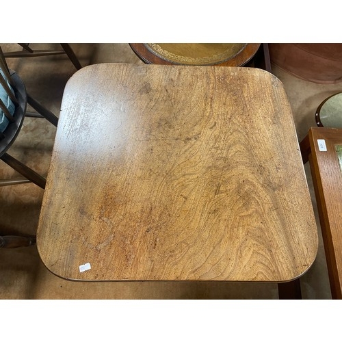 286A - A 19th Century mahogany table, the square top on three brass capped legs and casters