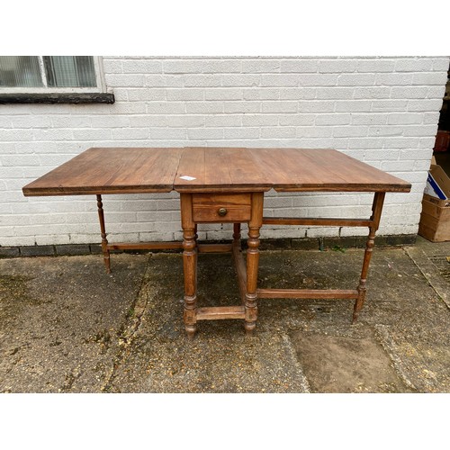 353 - A French pitch pine gateleg table, with end drawer -