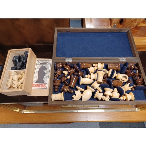 272 - A folding chess board with pieces, and another chess set -