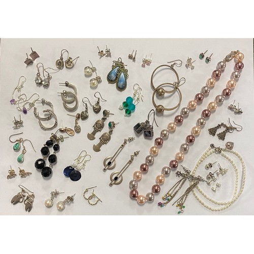 33 - Approximately 30 pairs of silver earrings, together with a freshwater pearl bracelet and a silver mo... 