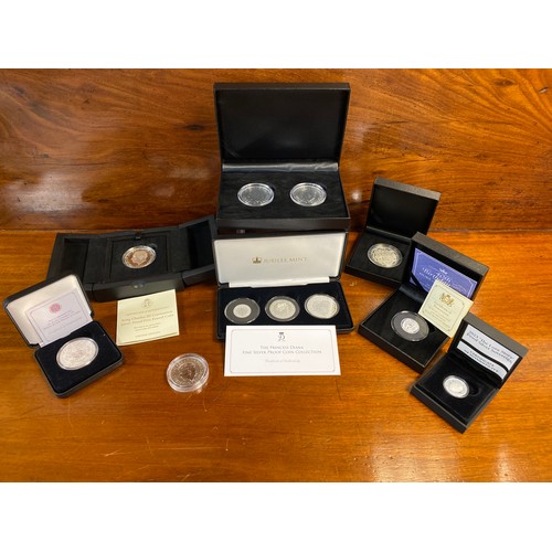 87 - A group of silver commemorative coins, including King Charles III coronation proof £5 and Princess D... 