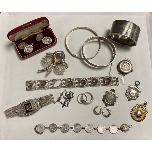 60 - A small quantity of silver jewellery including two bangles, bracelets, filigree brooch, napkin ring ... 