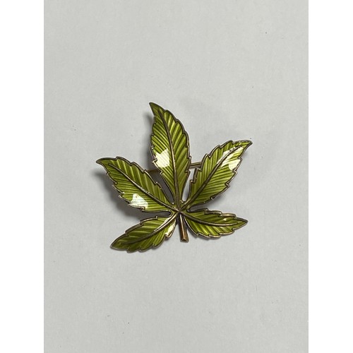 62 - A Norwegian silver gilt and enamel brooch of leaf form -