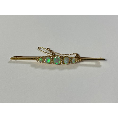 66 - A late Victorian/Edwardian opal and diamond set bar brooch, set with five graduated opals, spaced by... 