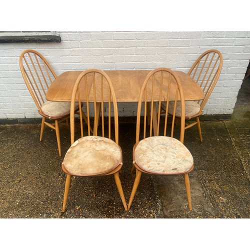 421 - An Ercol drop leaf dining table, with four Quaker chairs, labelled -