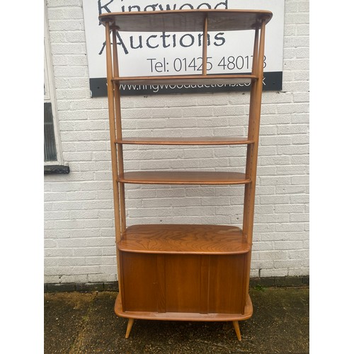 423 - An Ercol 'Giraffe' room divider/bookcase, No. 363, fixed and adjustable shelves over cupboard doors,... 