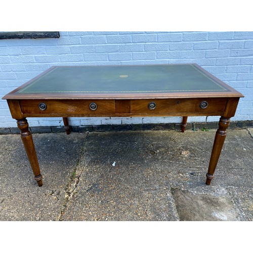 300 - An Edwardian writing table, with inset top over two frieze drawers and turned tapered legs -