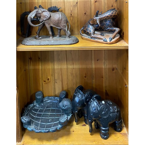 193 - A carved hardwood turtle shaped bowl, together with carved elephants etc -