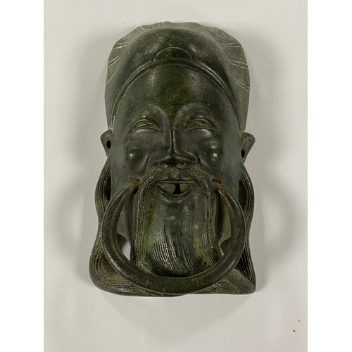 198 - A Chinese patinated brass figural door knocker -