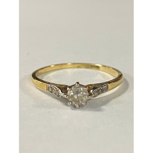 18 - A diamond single stone ring, the old cut diamond between diamond set shoulders, in 18ct gold and pla... 