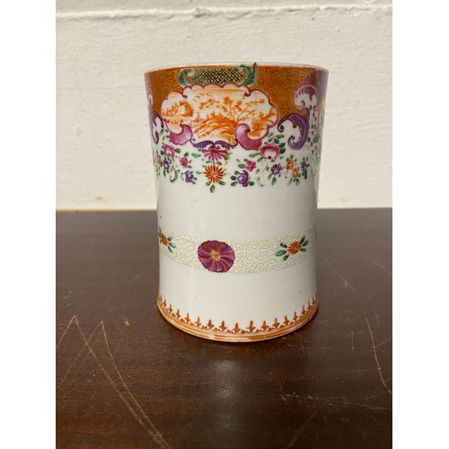 111 - A Chinese export mug, enamelled with floral decoration, the handle mounted with trefoils -