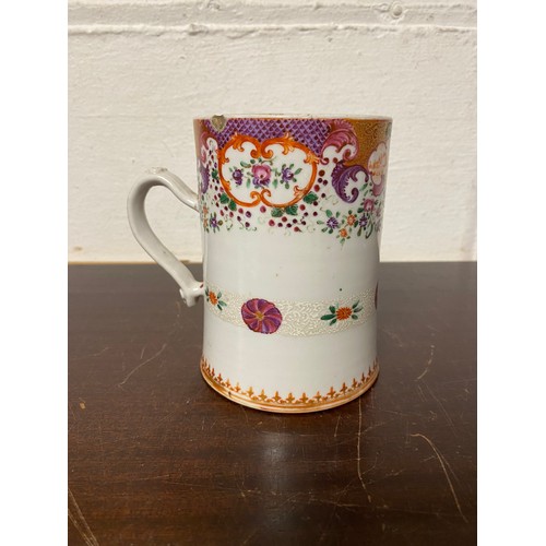 111 - A Chinese export mug, enamelled with floral decoration, the handle mounted with trefoils -