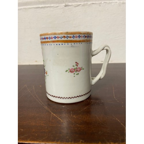 112 - A Chinese export mug, enamelled with floral decoration, with entwined handle -