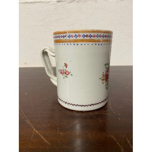 112 - A Chinese export mug, enamelled with floral decoration, with entwined handle -