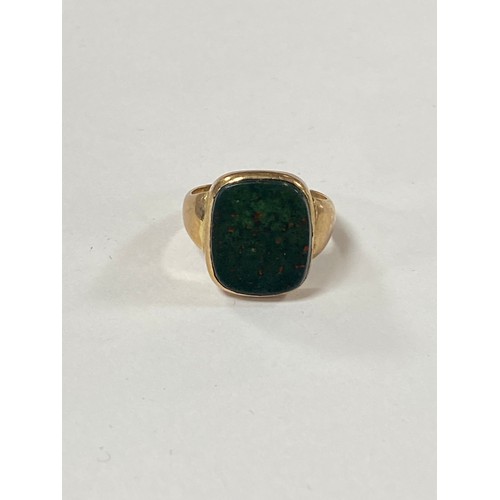 39 - A signet ring, set with a bloodstone panel, to yellow metal mount -