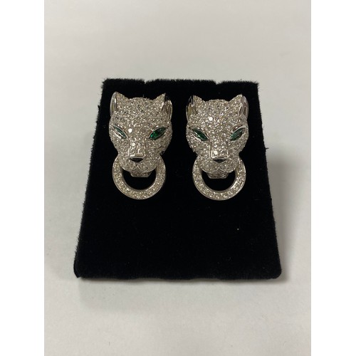 54 - A pair of silver and CZ set earrings, in the style of Cartier, each designed as a cat's head -