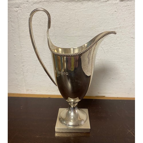 69 - A modern silver helmet shaped cream jug, London 1977 -