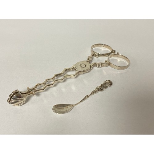 73 - A pair of antique silver sugar tongs, with shell bowls -