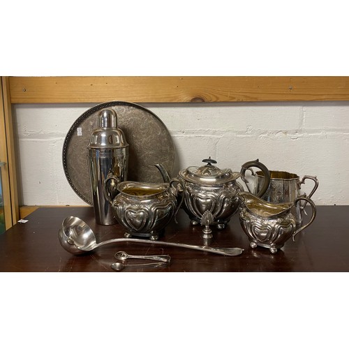 36 - A three piece silver plated tea set, and other metalwares -